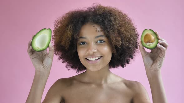 Professional Afro American Model Poses with Avocado Halves