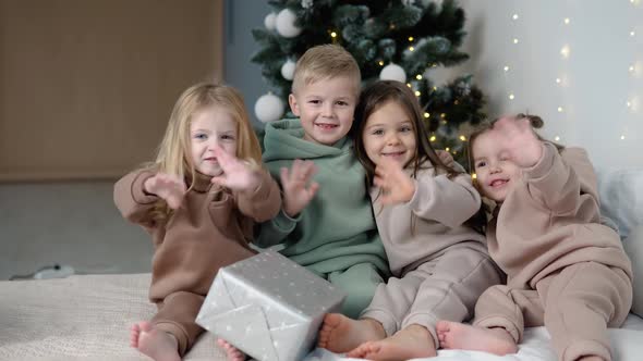 Children Showing Byebye Near Christmas Tree