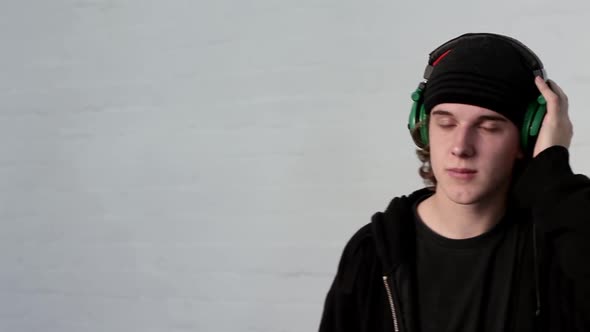 Teenage boy wearing headphones and listening to music