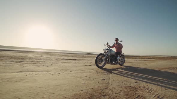 Motorcyclist Driving His Motorbike on the Dirt Road During Sunset Slow Motion