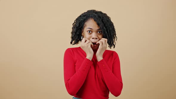 Young Emotional African American Woman in Red Sweater Waiting for Result and Enjoying Win Laughing