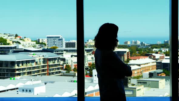 Silhouette of couple interacting with each other near the window