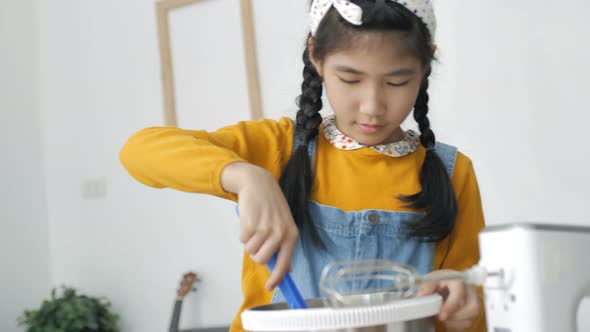 Pretty Asian girl baking homemade bakery cup cake.