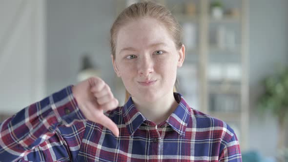 Close Up of Young Woman Doing Thumbs Down