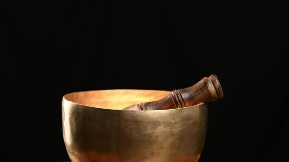 Copper singing bowl rotates around its axis