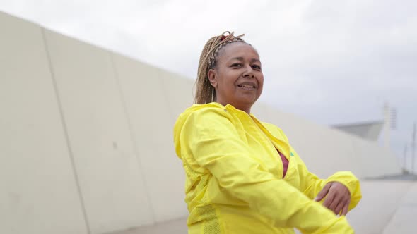 African Senior Woman Doing Workout Routine While Stretching Outdoor