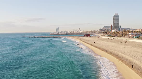 Drone Flying Above Sea Waves Washing Coastline in Resort City