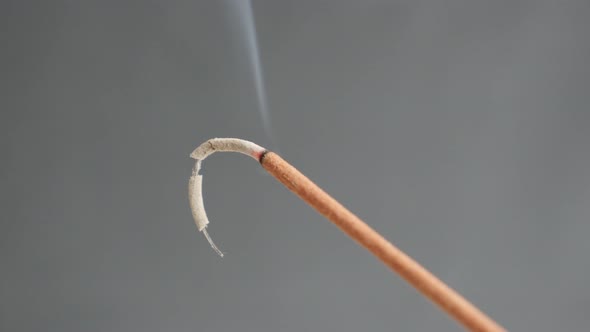 Smoke spreading from burned  fragrant incense stick   4K 2160p 30fps UltraHD footage - Close-up of a