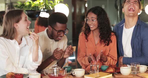 Joyful African American Young Guy in Glasses Gesturing While Telling Funny Story Multiethnic Friends