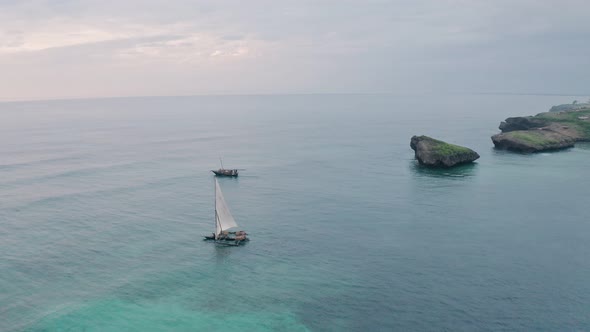 Fishing boats in Watamu Bay Beach at sunrise near Malindi, Kenya. Aerial drone view looking out