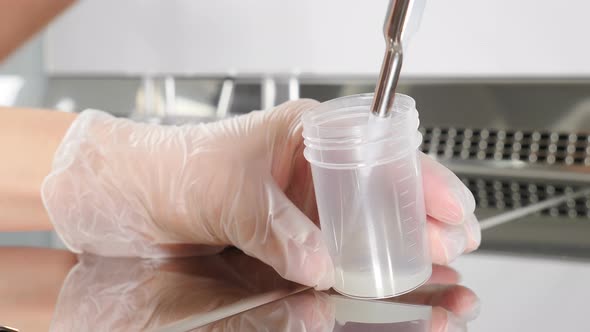 Laboratory Worker in Modern Microbiology Cabinet. Close-up of Doctor Working with Semen Sample