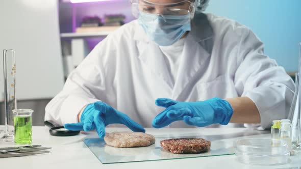 Medical Scientist Inspecting Minced Vegan Meat Wearing Protective Unform Working in Laboratory