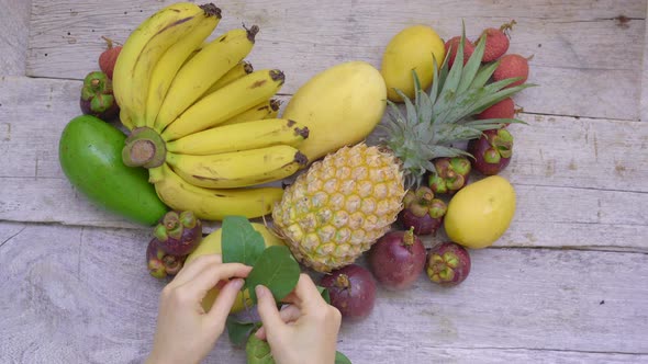 Top of View - Woman Makes a Heart Out of Lots of Tropical Fruits