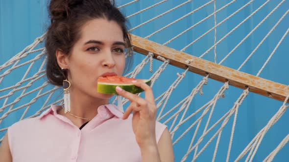 Woman Enjoying Watermelon on Hammock