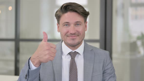 Portrait of Middle Aged Man showing Thumbs Up Sign