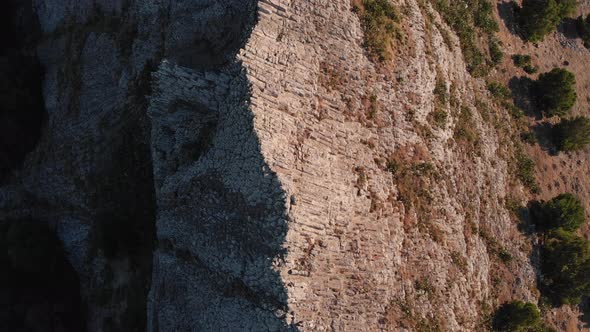 Dramatic flight directly above and along Ana Ferreira rocky stone steep jagged and pointy peak ridge
