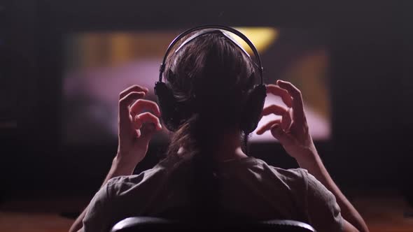 A Man Watches a Movie on a Computer Takes Off His Headphones Leaves the Room