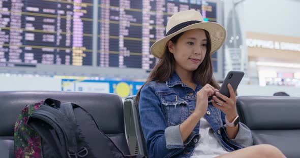 Woman use of mobile phone inside airport