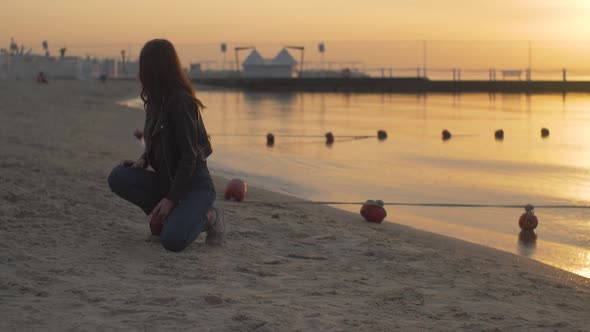 Female on the Beach Enjoying Sunrise with Dog