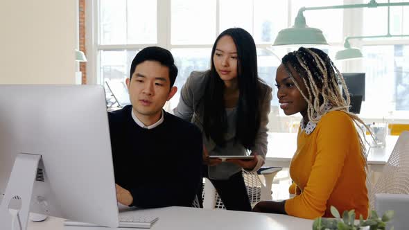 Business Executives Having Discussion over Personal Computer