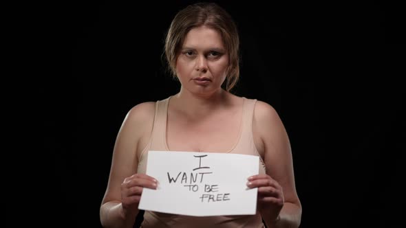 Hoping Plus Size Woman Raising I Want to Be Free Poster Looking at Camera