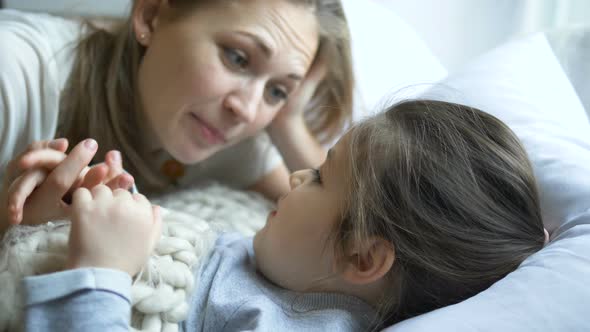 delighted lady tells tale to little daughter taking hand