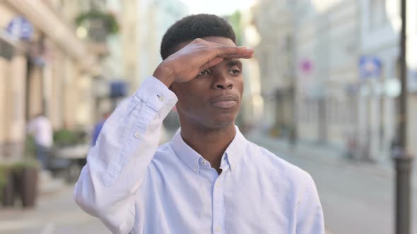 African Man Looking Around Searching Outdoor