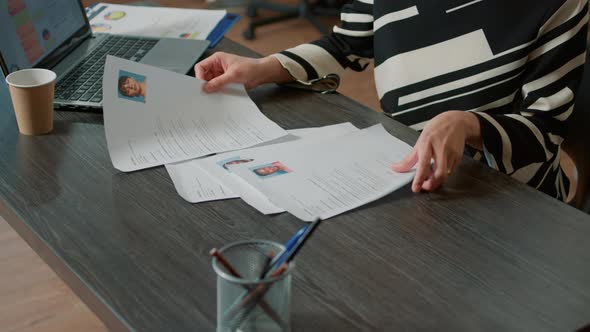 Female HR Employee Looking at Cv Resume to Hire Candidates