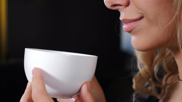 Portrait of Relaxed Girl Having Coffee Break. Beautiful Romantic Girl with Cup of Coffee or Tea