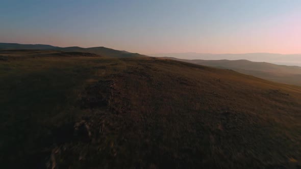 Aerial Field of Dry Yellow Grass. Steppe on Olkhon Island. Lake Baikal, Russia. Drone Footage Hills