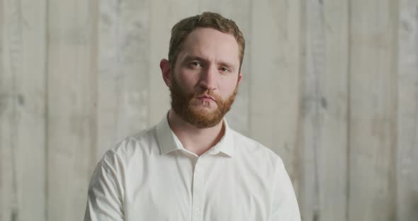 Young Attractive Man in a White Shirt Wears a Medical Mask