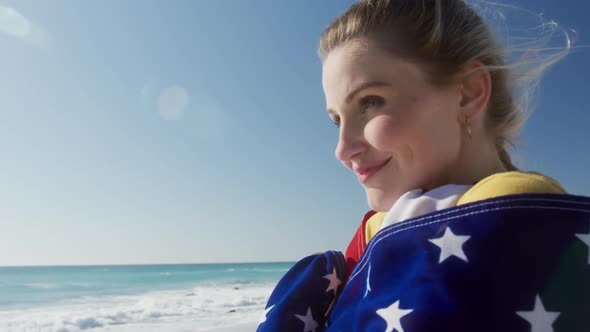 Woman holding American flag on the beach