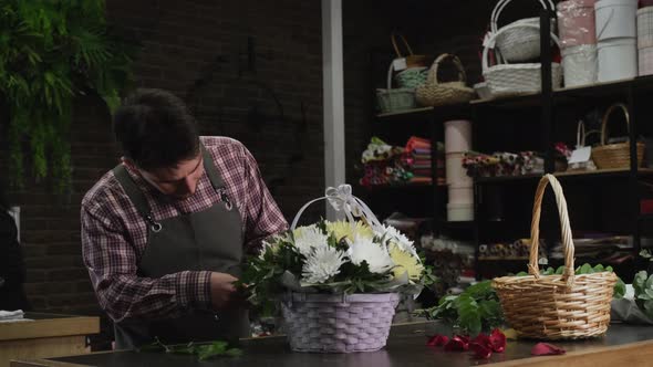 Florist Checking a Basket of White Chrysanthemums