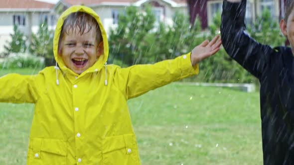 Happy Boys Jumping in Rain