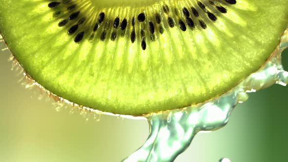 Super Slow Motion Macro Shot of Flowing Water From Kiwi Slice at 500Fps