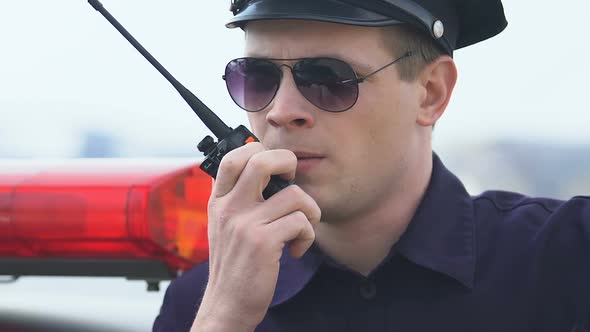 Policeman Accepting Emergency Call and Getting Into Patrol Car, Ready for Action