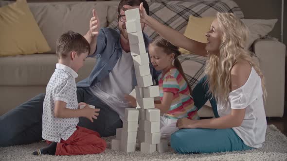 Family Building a Brick Tower alt