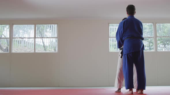 Judokas training by doing a randori on the judo mat