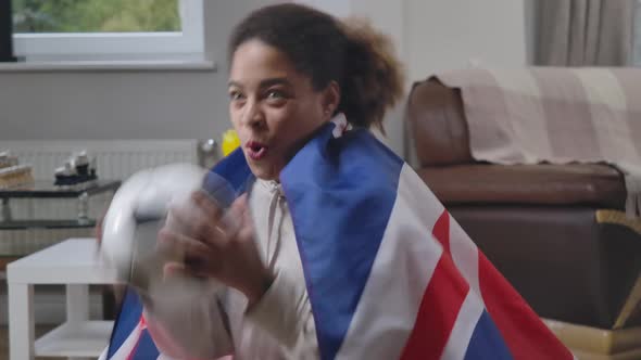 Happy Excited Soccer Fan Sitting at Home Cheering Watching TV Match