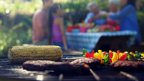 Corn, sausages and meat being grilled on barbecue 4k