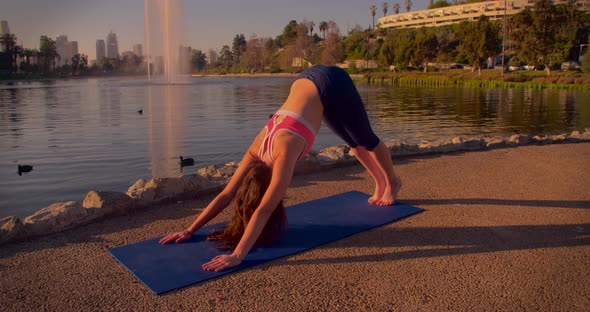 Woman Doing Yoga In The Park At Dawn