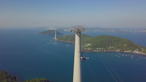 Cinematic Shot of Cable Cars Traveling on Rope Transit Over Magnificent Nature