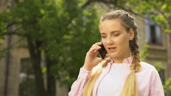 Glad Pregnant Woman Talking on Phone After Visiting Gynecologist, Gender Reveal