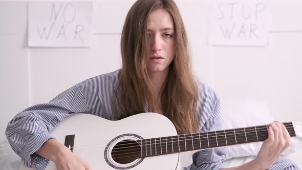 Woman Plays Guitar