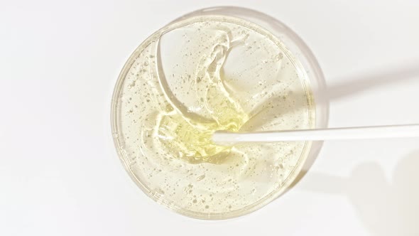 Transparent Cosmetic Gel Fluid in a Glass Bowl of Petri