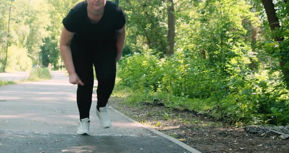 An Overweight Girl Runs in the Park