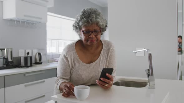 A senior african american woman spending time at home holding a cup social distancing in quarantine