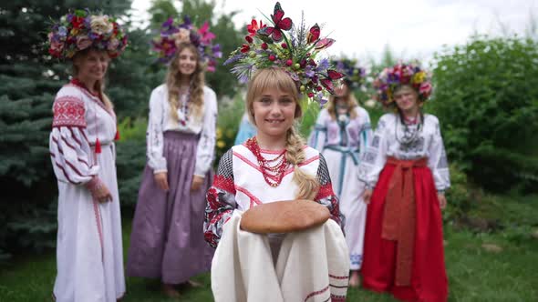 Portrait of Smiling Ukrainian Little Girl Standing with Traditional Bread on Towel Looking at Camera