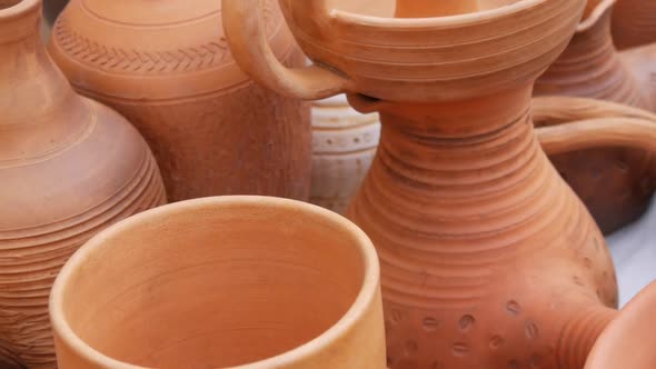 A Variety of Red Clay Utensils Ceramic Pottery Art on the Outdoor Counter