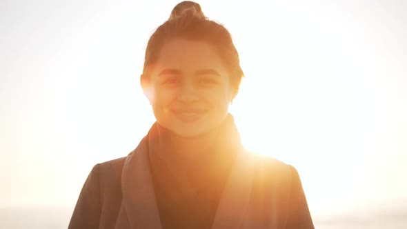 Portrait of Goodlooking Lady Standing Against Sea During Sunrise in Slowmotion